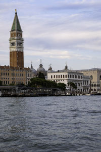 River amidst buildings against sky in city