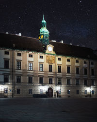 Low angle view of illuminated buildings in city at night