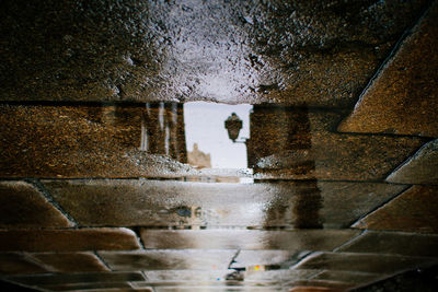 Reflection of building in puddle