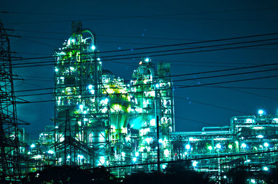 Low angle view of illuminated cityscape against sky at night