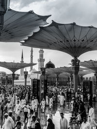 People at temple against sky in city