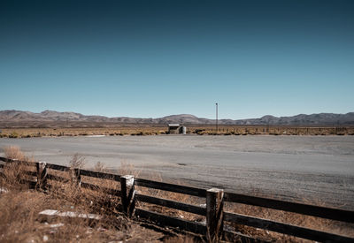 Scenic view of field against clear blue sky