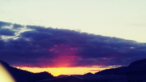 Scenic view of silhouette mountains against sky at sunset