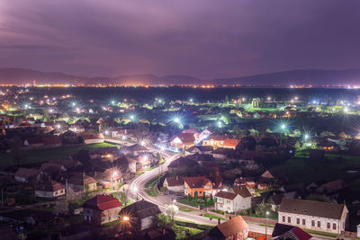 High angle view of illuminated buildings in city at night