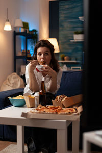 Young woman sitting at restaurant table