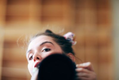 Portrait of woman holding mirror