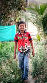 Portrait of a smiling young man standing on land