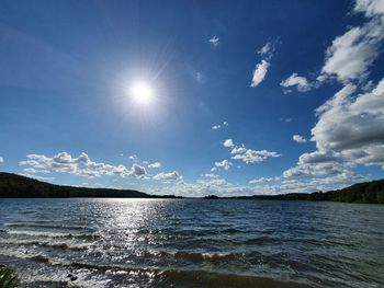 Scenic view of sea against bright sun