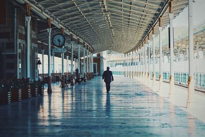 Man walking on railroad station platform