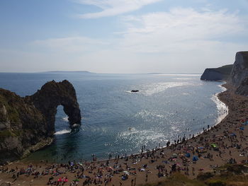 High angle view of people at beach against sky