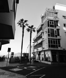 Road by building against clear sky