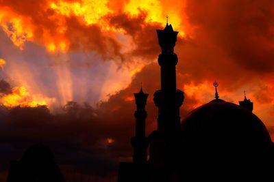 Low angle view of islamic center lombok against cloudy sky during sunset