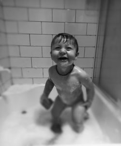Portrait of shirtless boy in bathroom