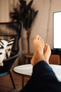 Low section of man on table at home