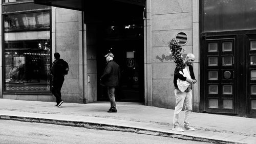 People walking on sidewalk in city