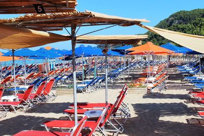 Multi colored umbrellas on beach against clear sky