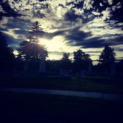 Scenic view of field against cloudy sky