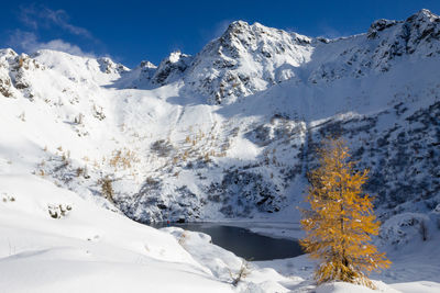 Scenic view of snowcapped mountains against sky