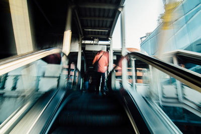 Rear view of man on escalator
