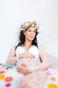 Portrait of woman with pink flower