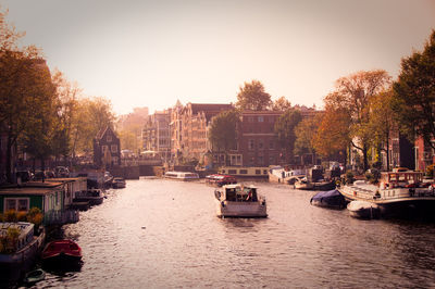 Boats moored on river in city