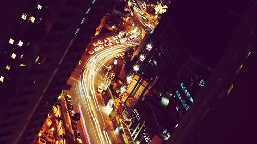 High angle view of illuminated lights in city at night