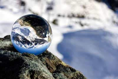 Close-up of crystal ball on rock