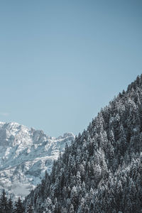 Scenic view of snowcapped mountains against clear sky