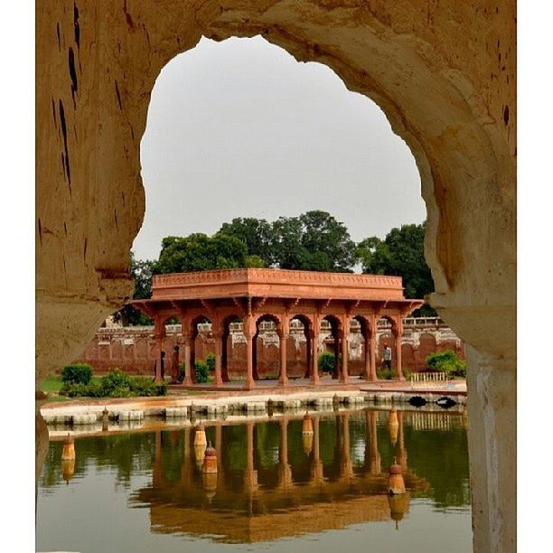 architecture, built structure, water, arch, clear sky, waterfront, reflection, famous place, history, building exterior, arch bridge, travel destinations, tourism, river, architectural column, travel, bridge - man made structure, tranquility, tree, connection