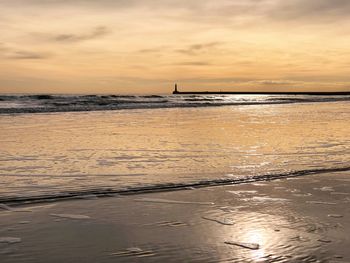 Scenic view of sea against sky at sunset