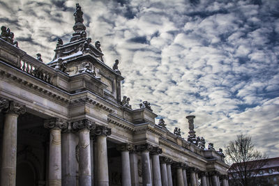 Low angle view of historical building against cloudy sky