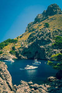 Scenic view of sea against mountain range