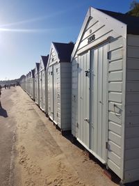 Buildings on beach against sky during sunny day