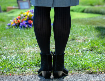 Low section of woman standing on grass