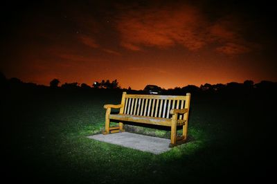 Empty bench at sunset