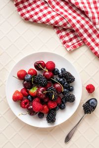 High angle view of strawberries in plate on table