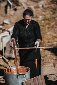 Woman making equipment on field