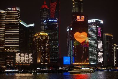 Illuminated modern buildings in city at night