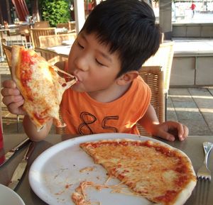 Full length of boy eating ice cream in plate