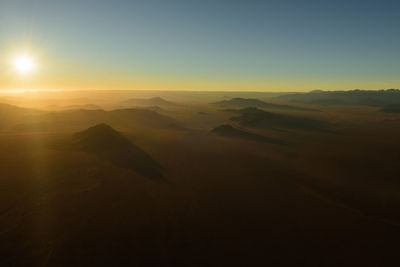 Scenic view of desert against sky during sunset