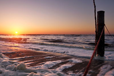 Scenic view of sea against clear sky during sunset