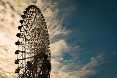 Low angle view of ferris wheel against sky