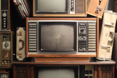 Old-fashioned television sets on table