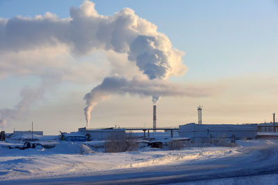 Smoke emitting from chimney against sky