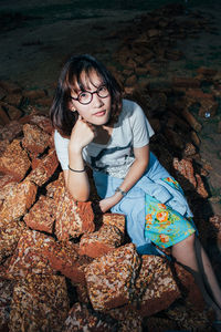 Portrait of smiling young woman sitting outdoors