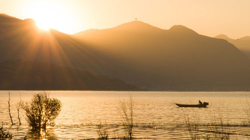 Scenic view of silhouette mountains against sky during sunset