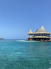 Scenic view of sea against clear blue sky