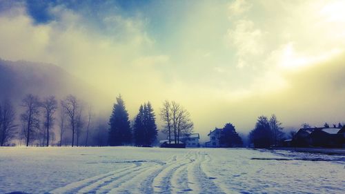 Snow covered field against sky