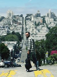 Young man standing in city