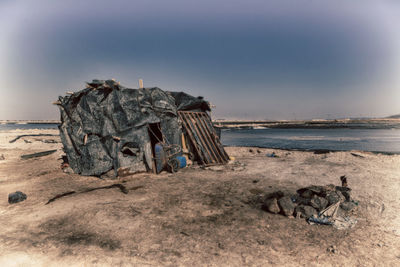 Panoramic view of rocks on beach against sky